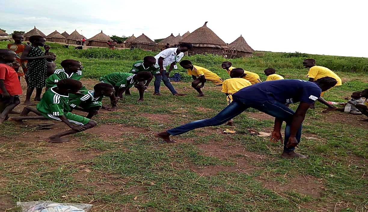 Children participating in games and cultural dances at a Child Friendly Space