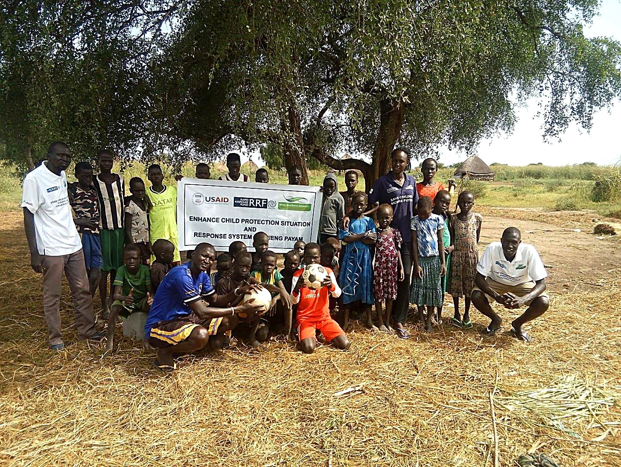 Children in Urieng Payam, South Sudan, gathered after a Child Friendly Space activity