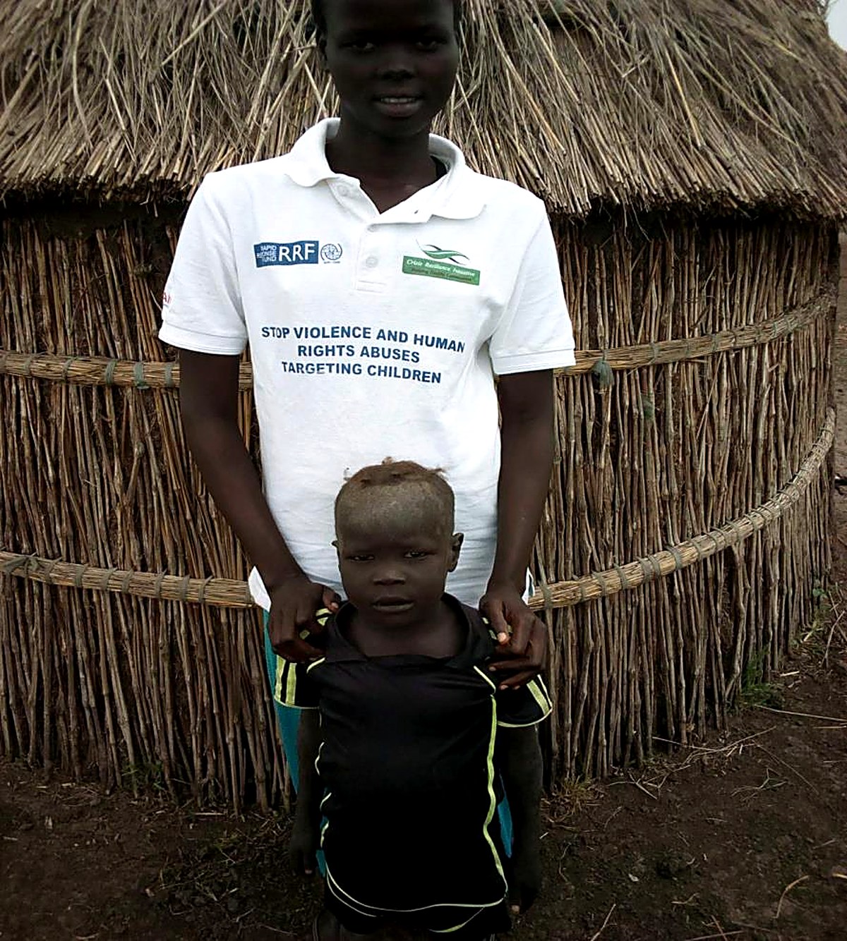 A CRI family tracing and reunification caseworker with a separated child in Maiwut County